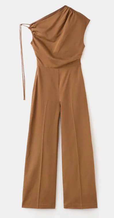 Tan one-shoulder jumpsuit, photographed flat against a plain backdrop